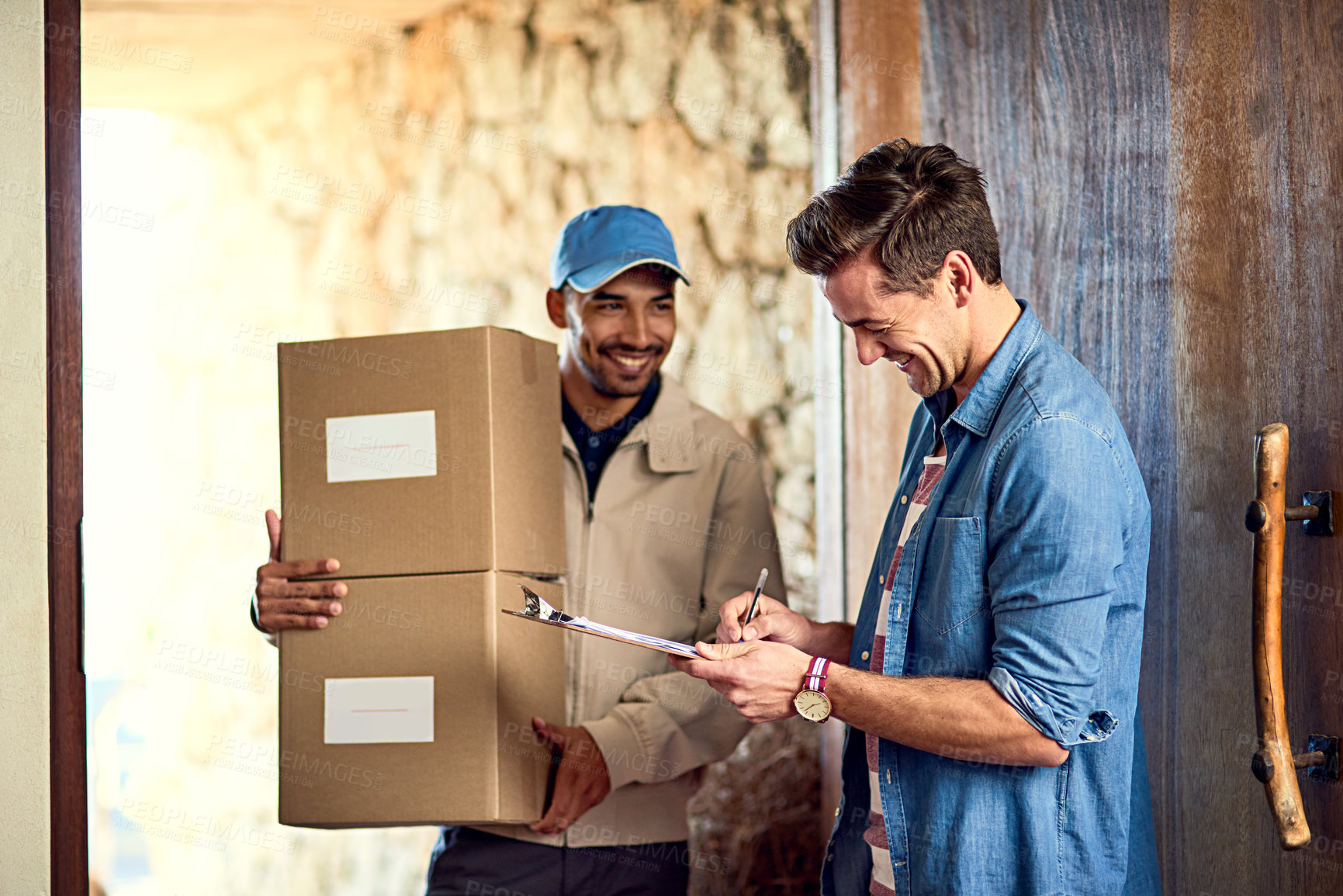 Buy stock photo Cropped shot of a courier making a delivery to a customer at his home
