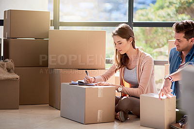 Buy stock photo Cropped shot of a young couple moving house