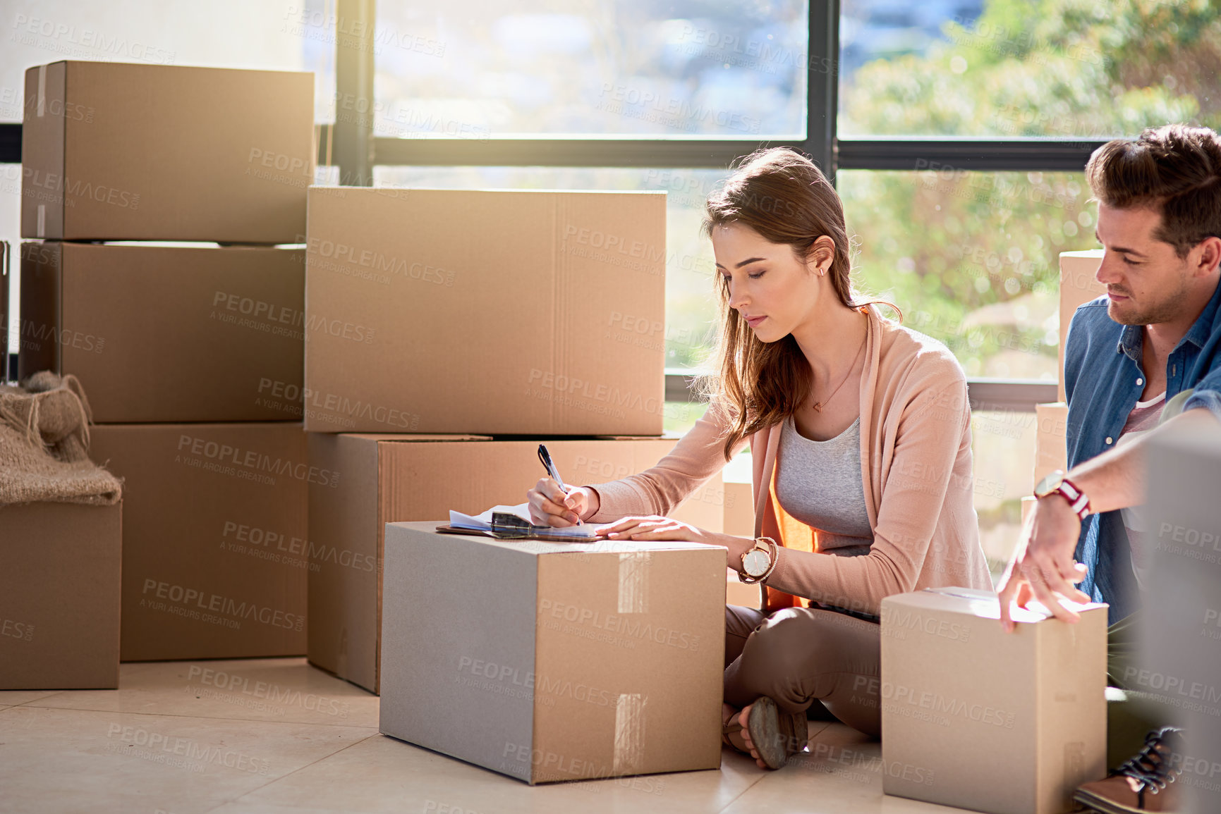 Buy stock photo Couple, new home and box with documents on floor for mortgage loan, investment or property agreement. Man, woman and cardboard with writing in house for real estate, relocation and signature of paper