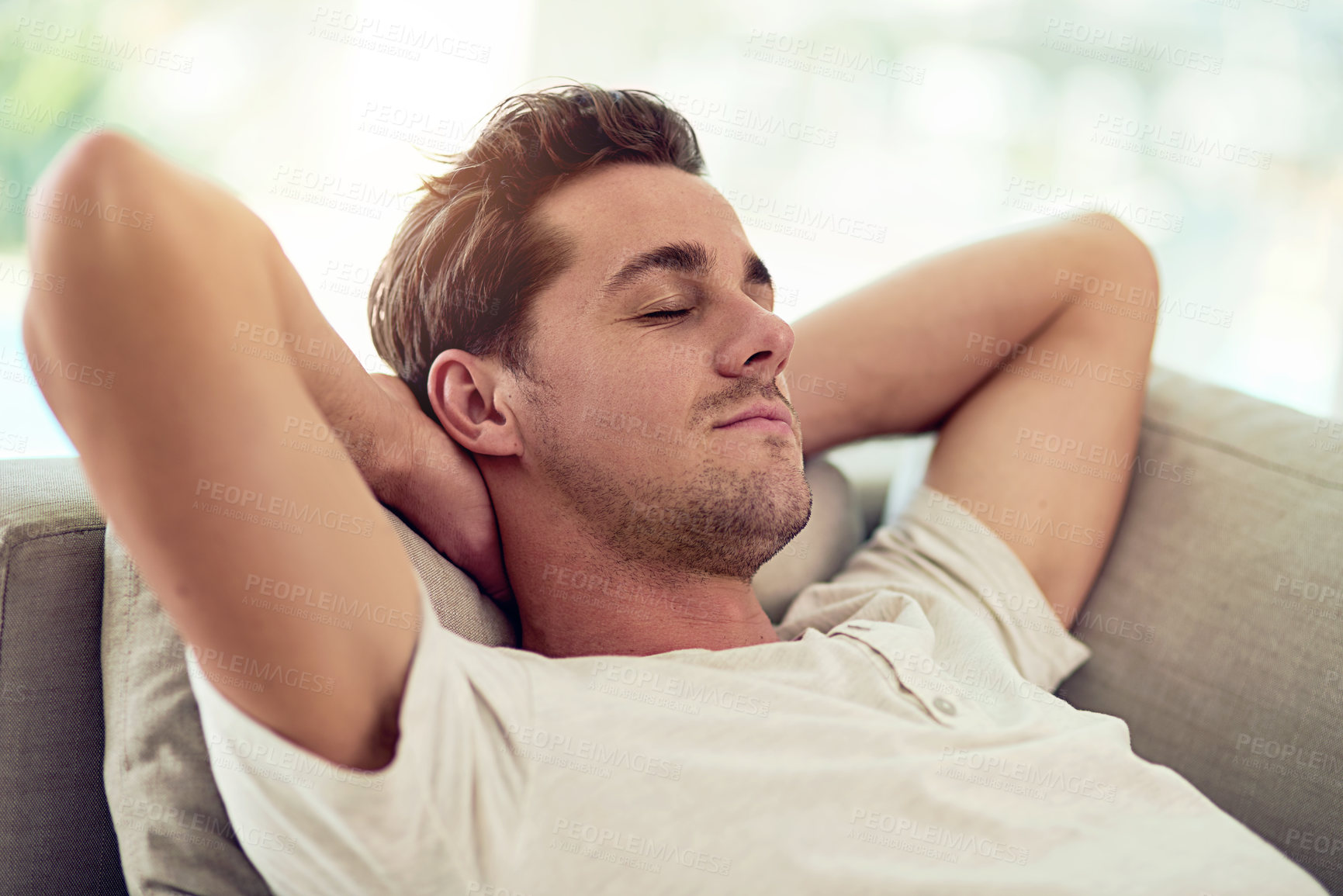 Buy stock photo Shot of a young man relaxing on the sofa at home