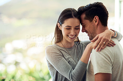 Buy stock photo Shot of a happy young couple in a loving embrace