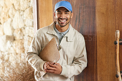 Buy stock photo Cropped portrait of a handsome young delivery man with a clipboard