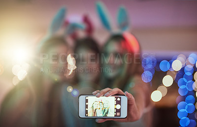 Buy stock photo Cropped shot of a group of friends taking a selfie while partying in a club