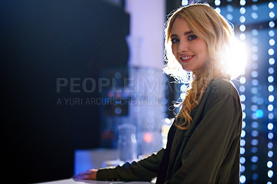Buy stock photo Portrait of an attractive young woman standing in a nightclub