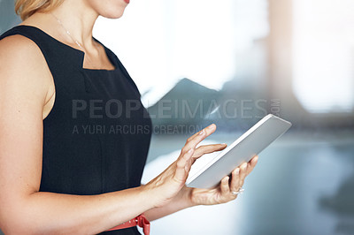 Buy stock photo Shot of an unidentifiable businesswoman using a tablet in the office