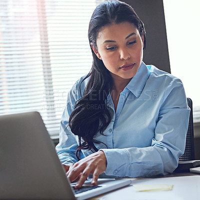 Buy stock photo Shot of an attractive businesswoman using her laptop in the office