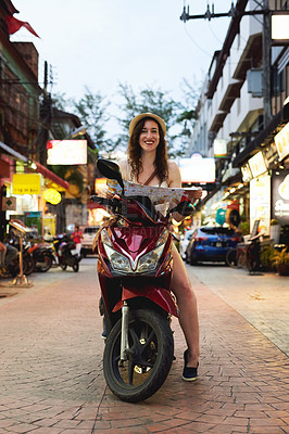 Buy stock photo Portrait of a young woman using a map while travelling on a scooter in a foreign city