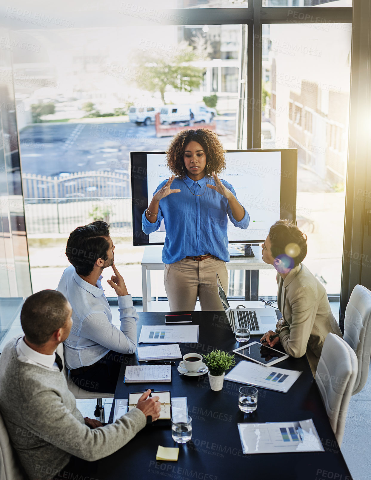 Buy stock photo Black woman, coach and discussion with team in meeting, presentation or conference on project at office. Female person or speaker talking to employees with paperwork, documents or ideas at workplace