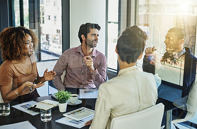 Buy stock photo Shot of a group of colleagues meeting in the boardroom