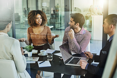 Buy stock photo Shot of a group of colleagues meeting in the boardroom