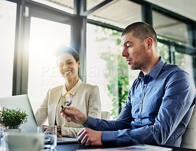 Buy stock photo Shot of two colleagues meeting in their office