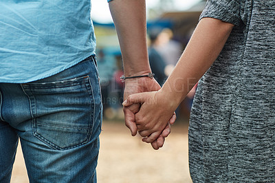 Buy stock photo Rearview shot of an unidentifiable couple holding hands while exploring an outdoor market