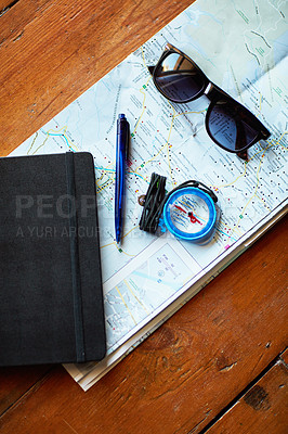 Buy stock photo Shot of a map and adventure gear arranged on a table