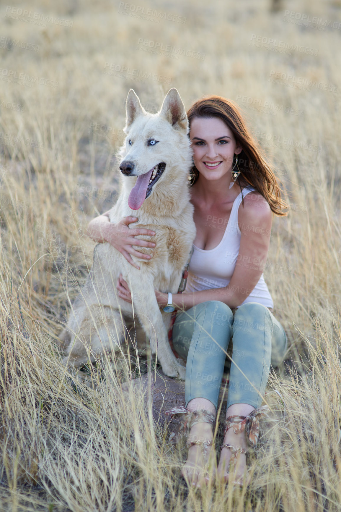 Buy stock photo Portrait of an attractive young woman bonding with her dog outdoors