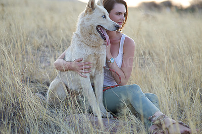 Buy stock photo Hug, comfort and woman with dog in field for travel, adventure and behaviour training while bonding in nature together. Puppy, love or girl with pet Husky in countryside with care, support and trust