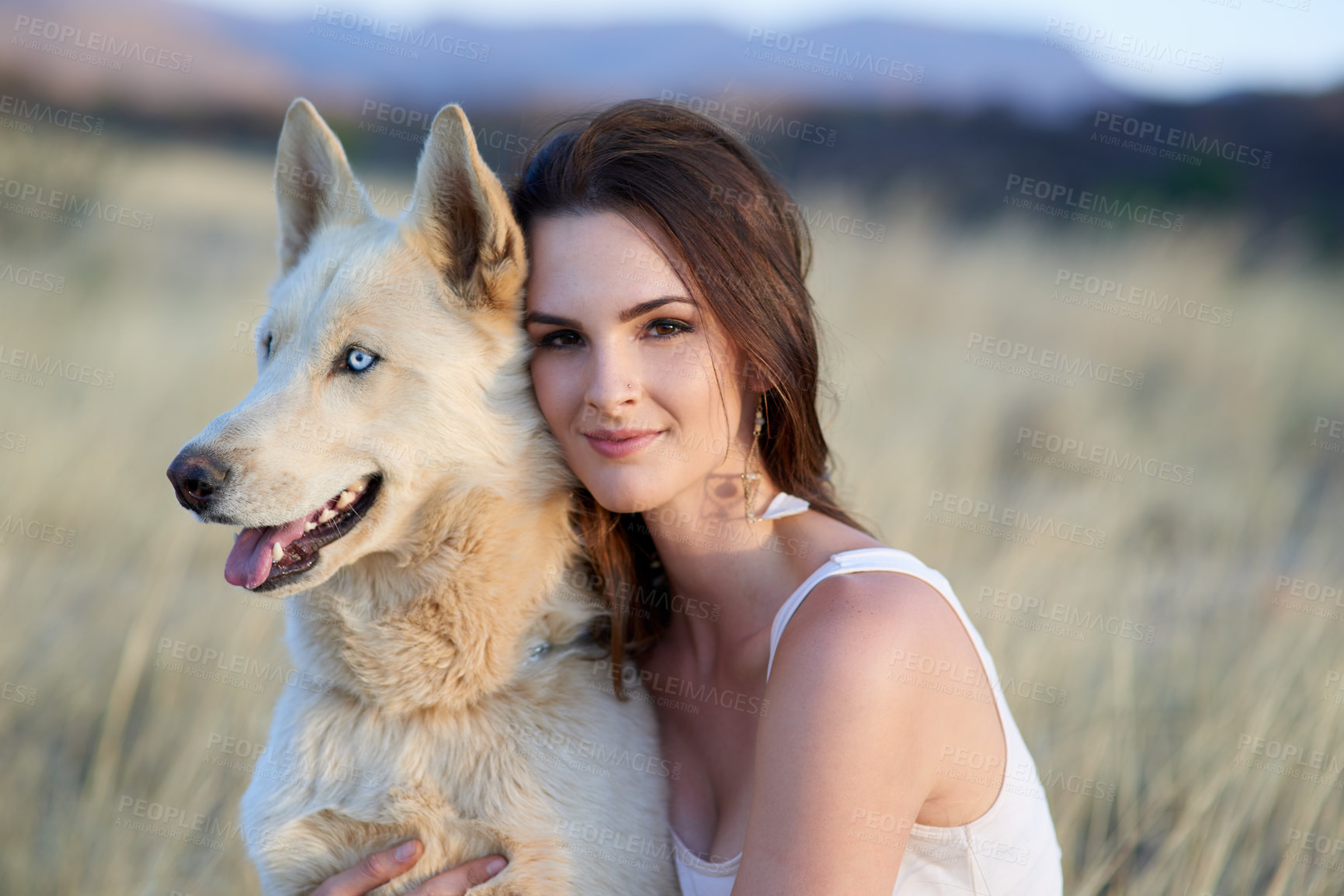 Buy stock photo Portrait of an attractive young woman bonding with her dog outdoors