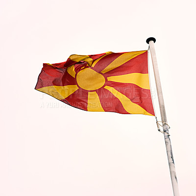 Buy stock photo Macedonia, flag and pole with wind on white background for patriotic, heritage and national pride for identity or Macedonian. Red, yellow and emblem with mockup hanging for country and culture.