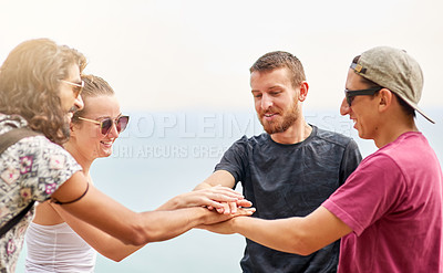 Buy stock photo Shot of a group of friends making a pact while relaxing outside together