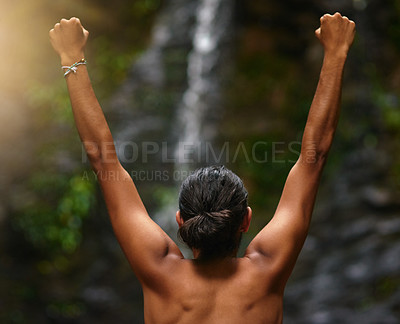 Buy stock photo Rearview shot of an unidentifiable person celebrating a victory in the jungle