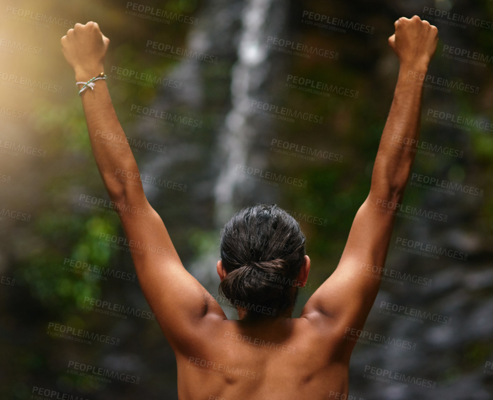 Buy stock photo Rearview shot of an unidentifiable person celebrating a victory in the jungle