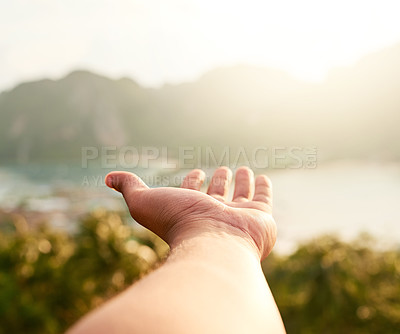 Buy stock photo Cropped shot of an unidentifiable person holding out their hand while admiring a coastal view