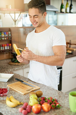 Buy stock photo Fruit, smile or man with banana in kitchen for breakfast, diet or organic nutrition for gut health, balance or wellness at home. Healthy, brunch or superfoods, detox or salad bowl for vegan meal prep