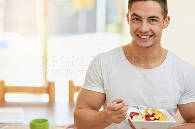 Buy stock photo Man, portrait and eating a fruit salad in home for breakfast with confidence, healthy meal and nutrition in dining room. Person, wellness and nutritionist with organic brunch for vegan diet or mockup