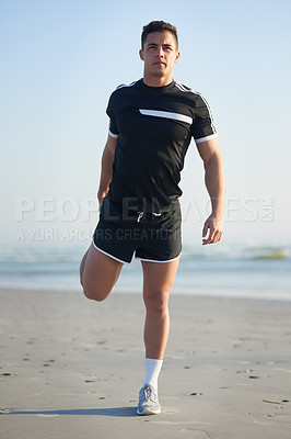 Buy stock photo Full length portrait of a handsome young man warming up before a workout on the beach