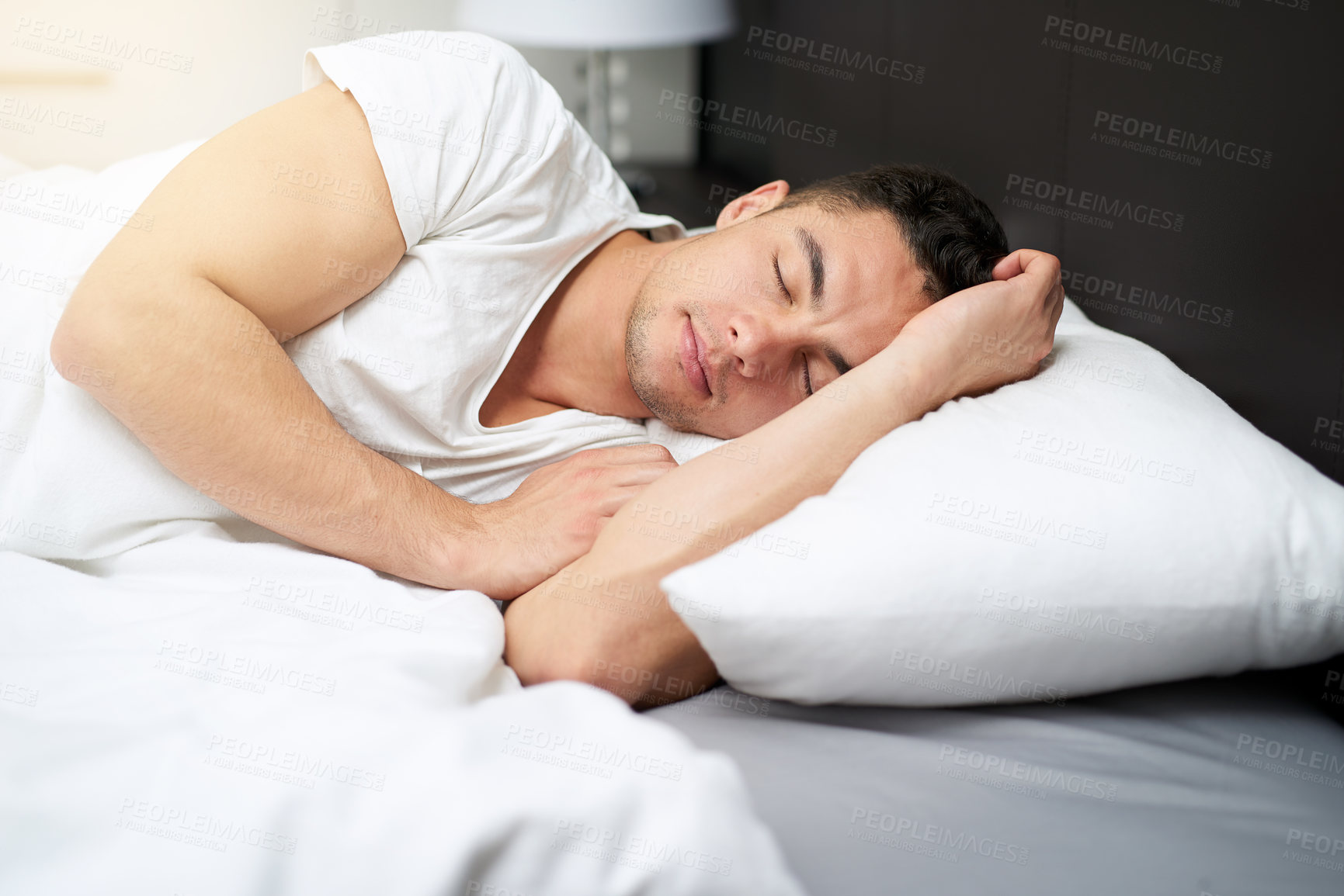 Buy stock photo Cropped shot of a handsome young man asleep in his bed0