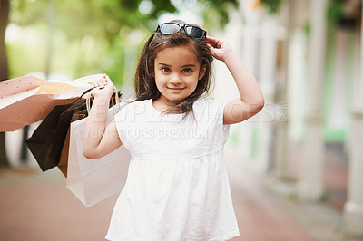 Buy stock photo Young girl, shopping bags and sunglasses in portrait at mall or sidewalk for discount, sale and purchase. Smile, female child and retail therapy for learning about money with fashion clothing promo