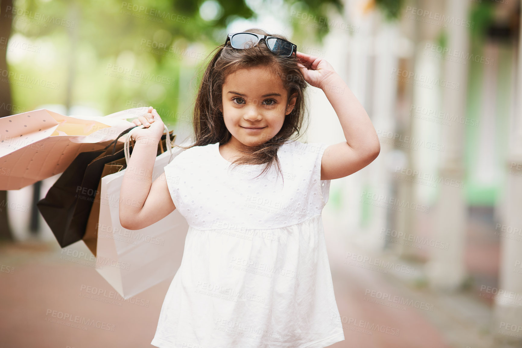 Buy stock photo Young girl, shopping bags and sunglasses in portrait at mall or sidewalk for discount, sale and purchase. Smile, female child and retail therapy for learning about money with fashion clothing promo