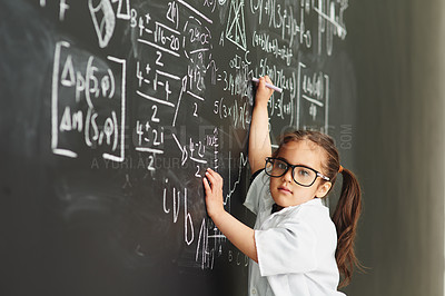 Buy stock photo Shot of an academically gifted young girl solving a math equation