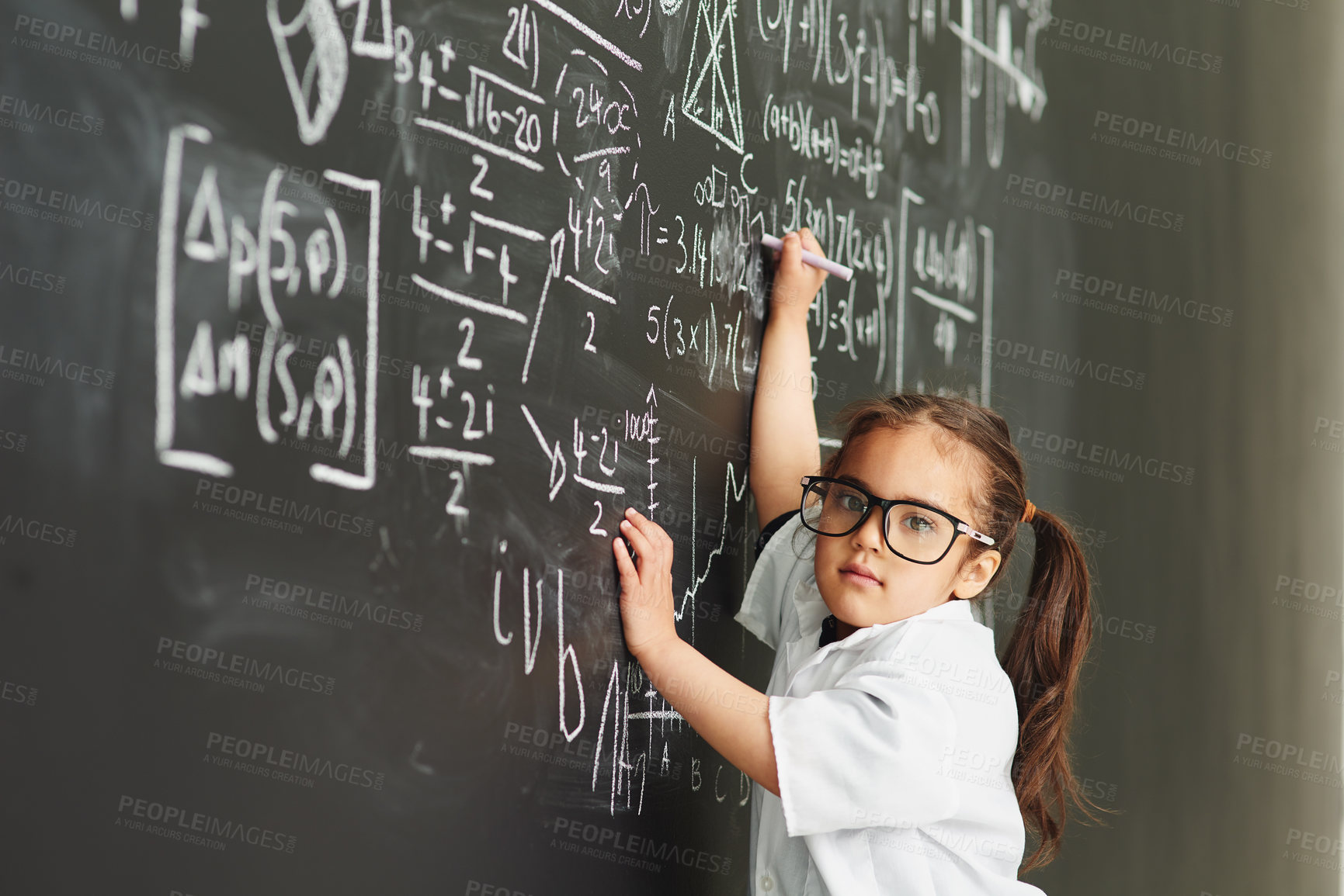 Buy stock photo Shot of an academically gifted young girl solving a math equation