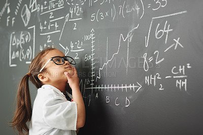 Buy stock photo Shot of an academically gifted young girl solving a math equation