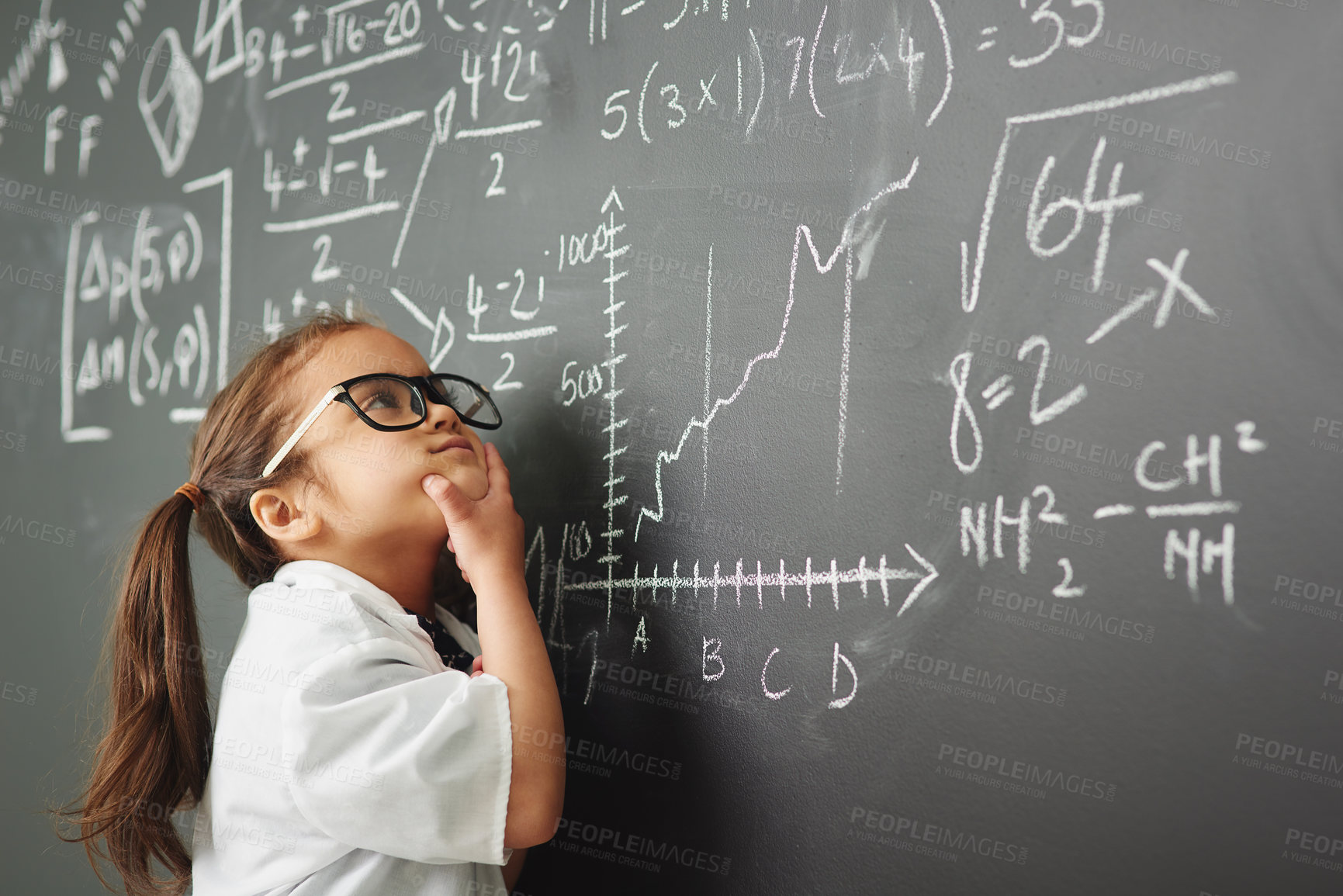 Buy stock photo Shot of an academically gifted young girl solving a math equation