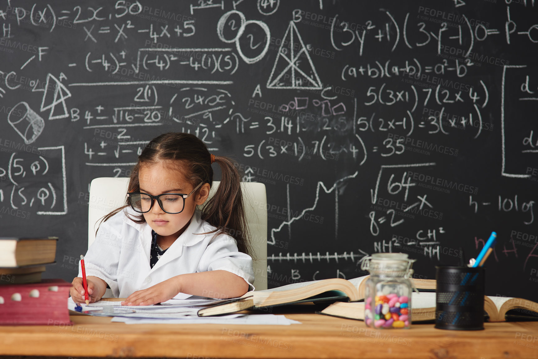 Buy stock photo Shot of an academically gifted young girl working in her classroom