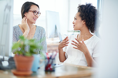 Buy stock photo Shot of two young female designers discussing work in the office