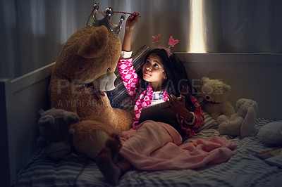 Buy stock photo Girl, teddy bear and tablet in bedroom at night for games, movies and online streaming. Technology, child and relax with toys in home for entertainment, video call and internet for communication app 