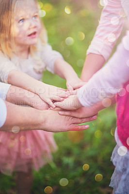 Buy stock photo Kids, family and hands together for team, support and solidarity outdoor on bokeh in summer. Children, huddle and people in nature for community, success or connection for achievement celebration