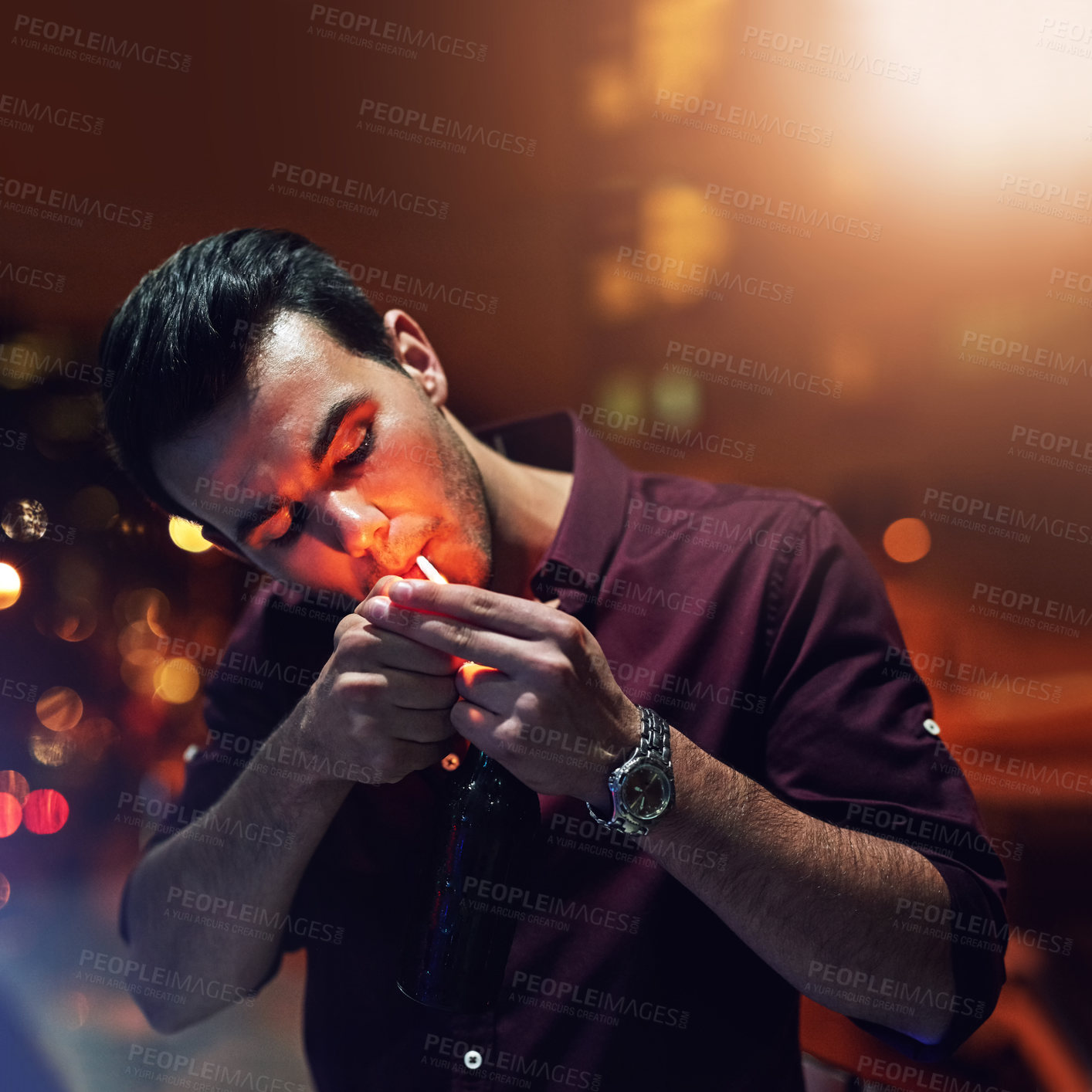 Buy stock photo Relax, nightclub and man lighting a cigarette to smoke for addiction, habit and stress relief. Dangerous, smoker and male person from Portugal puffing tobacco on balcony, break and nightlife in city