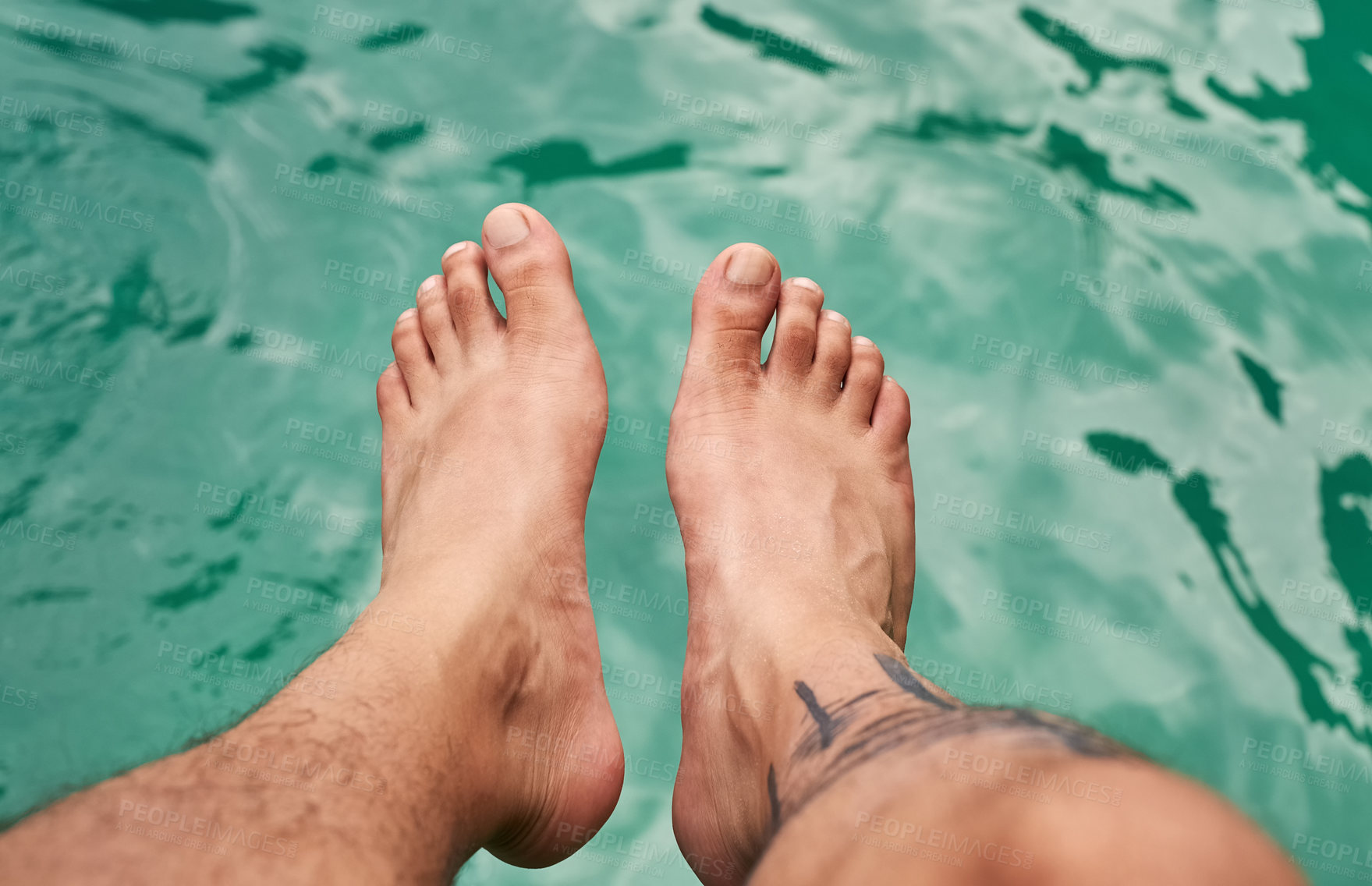 Buy stock photo High angle shot of a man's feet above the water