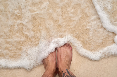 Buy stock photo High angle shot of a man's feet at the beach