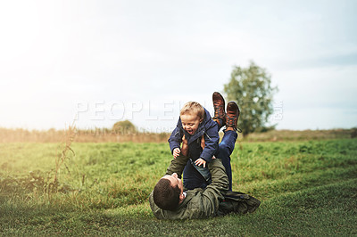 Buy stock photo Shot of a father bonding with his son outside