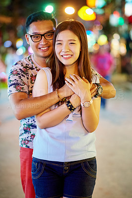 Buy stock photo Shot of a happy young couple spending the night out in the city