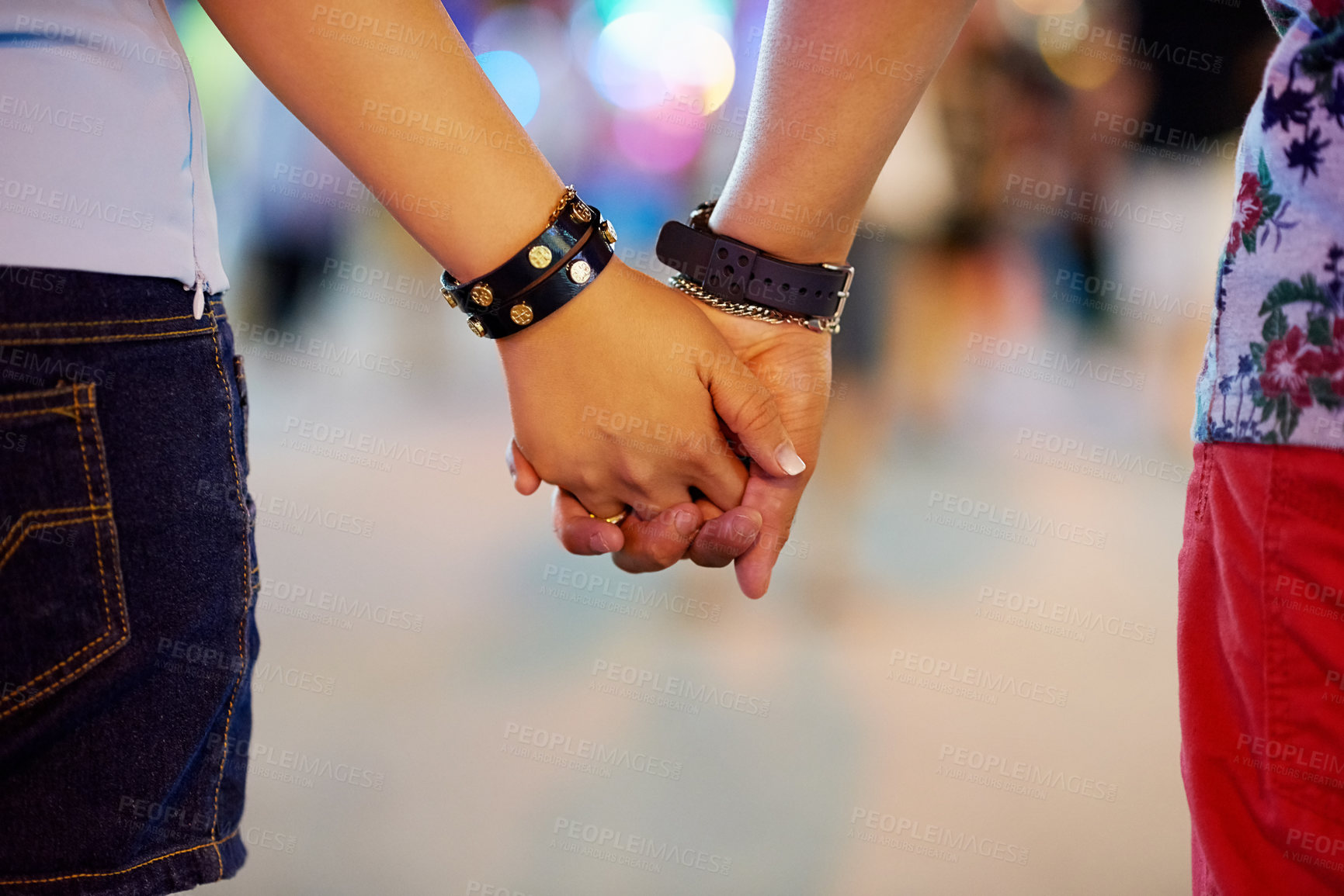 Buy stock photo Cropped shot of a couple holding hands while out in the city
