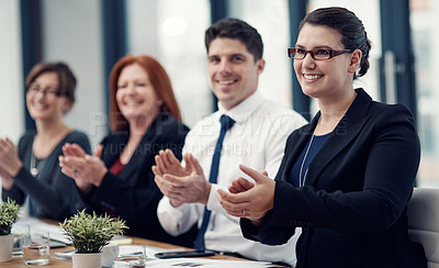 Buy stock photo Cropped shot of a group of businesspeople applauding while sitting in a boardroom