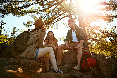 Buy stock photo Shot of three young people hiking while on an overseas trip