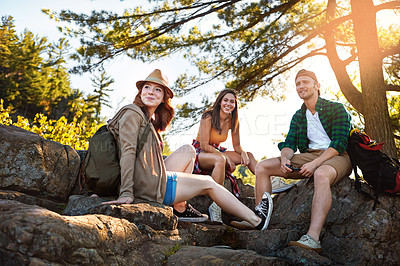 Buy stock photo Shot of three young people hiking while on an overseas trip