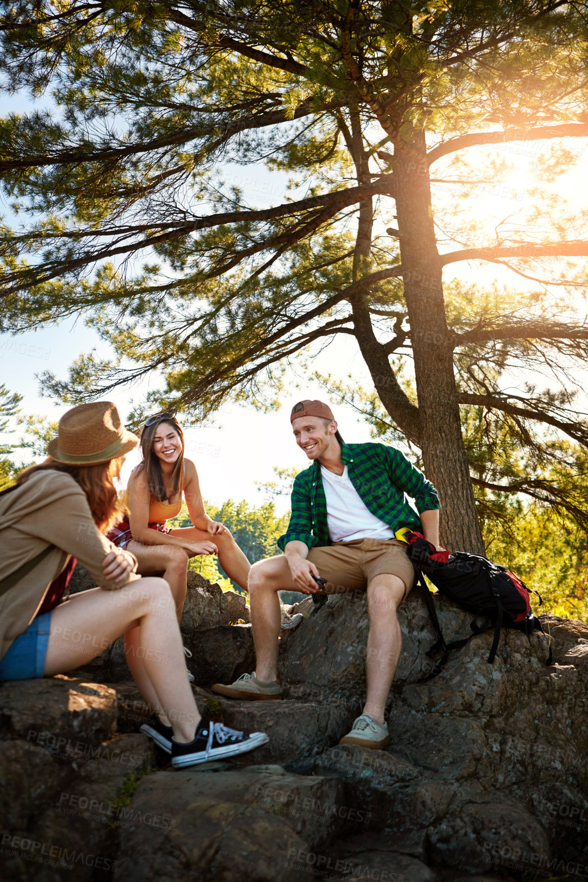 Buy stock photo Shot of three young people hiking while on an overseas trip