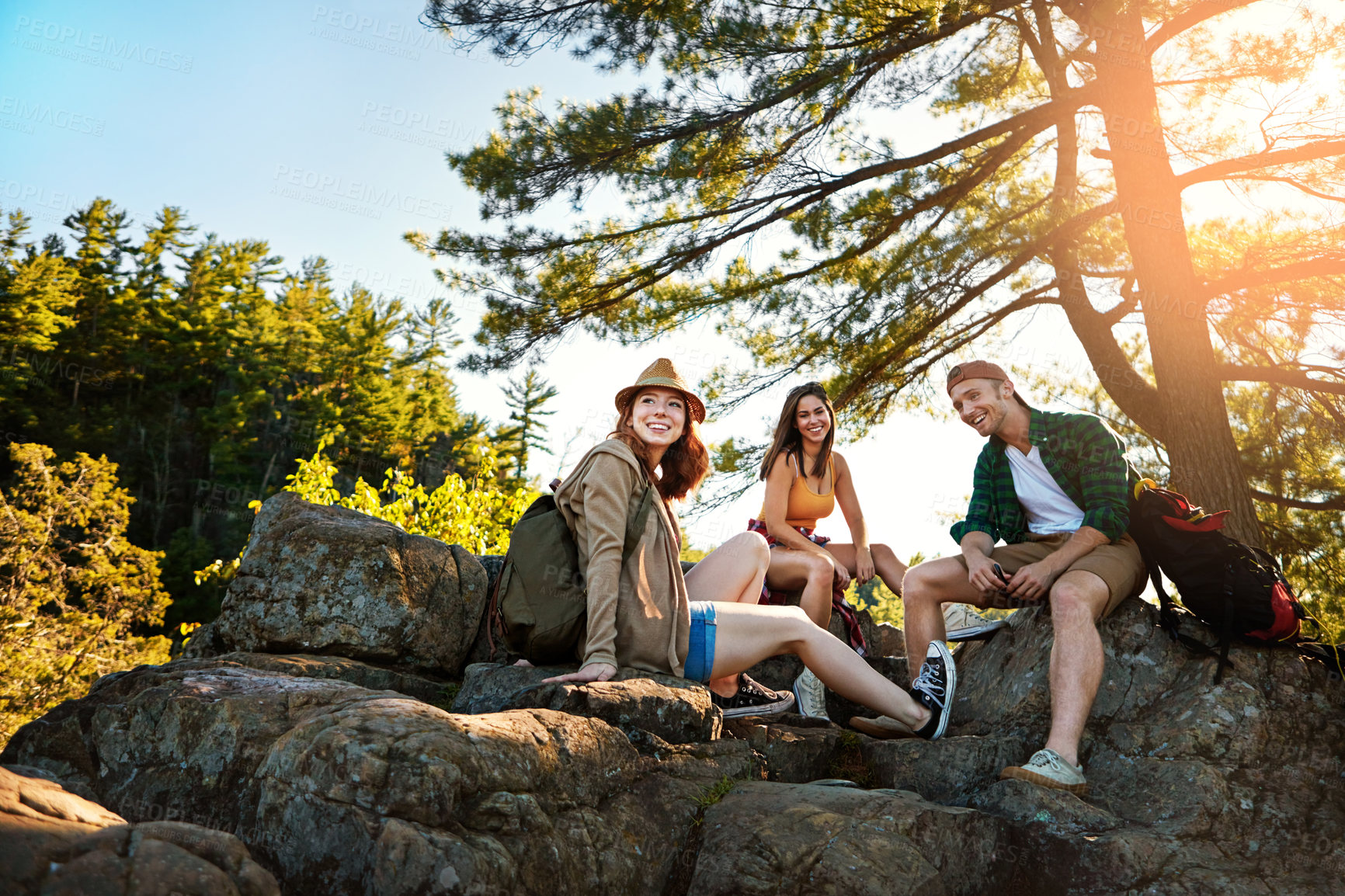Buy stock photo Relax, hiking and rock with friends in nature for mountain explore, adventure and bonding. Eco tourism, trekking holiday and hiker break with group of people outdoor for travel, resting and vacation